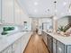 Spacious kitchen featuring white cabinets, quartz countertops, and a large island at 708 Fox Edge Ct, Oviedo, FL 32765