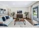 Bright living room with hardwood floors, comfortable sofas, and access to patio at 708 Fox Edge Ct, Oviedo, FL 32765