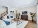 Living room features hardwood floors, comfy sofas, and a large TV at 708 Fox Edge Ct, Oviedo, FL 32765