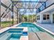 Stunning pool and spa with covered patio and lush green surroundings at 708 Fox Edge Ct, Oviedo, FL 32765