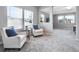 Relaxing sitting area with two armchairs and a view of the bedroom at 708 Fox Edge Ct, Oviedo, FL 32765