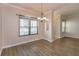 Inviting dining room with wood-look floors, large windows, and modern lighting fixture at 2356 Wales Ct, Ocoee, FL 34761