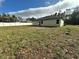 Backyard of the house with unkempt grass at 6807 Sw 153Rd Place Rd # 6807, Ocala, FL 34473