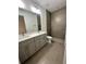 Bathroom with gray double vanity and shower at 6807 Sw 153Rd Place Rd # 6807, Ocala, FL 34473