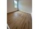 Spacious bedroom featuring wood-look floors and a window at 6807 Sw 153Rd Place Rd # 6807, Ocala, FL 34473