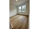Bright bedroom with wood-look floors and large windows at 6807 Sw 153Rd Place Rd # 6807, Ocala, FL 34473