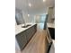 Kitchen with gray cabinets, island, and stainless steel appliances at 6807 Sw 153Rd Place Rd # 6807, Ocala, FL 34473