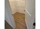 Well-lit laundry room with wire shelving and wood-look floors at 6807 Sw 153Rd Place Rd # 6807, Ocala, FL 34473