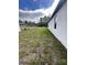 House side yard with unkempt grass at 6807 Sw 153Rd Place Rd # 6807, Ocala, FL 34473