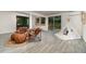 Inviting finished basement area with tile floors, comfortable seating, and access to the outdoors at 2524 Dellwood Dr, Orlando, FL 32806