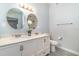 Elegant bathroom with double sinks, round mirrors, and modern lighting fixtures at 2524 Dellwood Dr, Orlando, FL 32806