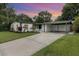 Charming single-story home with well-maintained landscaping and a covered carport at dusk at 2524 Dellwood Dr, Orlando, FL 32806