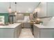 Modern kitchen with stainless steel appliances, light gray cabinetry, and a spacious layout at 2524 Dellwood Dr, Orlando, FL 32806