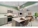 Open-concept kitchen featuring an island with seating that overlooks the living room at 2524 Dellwood Dr, Orlando, FL 32806