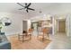 Bright living room with modern ceiling fan, tile floors, stylish furniture, and open layout to the kitchen at 2524 Dellwood Dr, Orlando, FL 32806