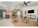 Open-concept living room and kitchen with modern furnishings, a ceiling fan, and tile floors at 2524 Dellwood Dr, Orlando, FL 32806
