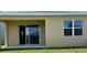 Home featuring a covered back porch and sliding glass doors to the back yard at 1926 Church Lake St, Groveland, FL 34736
