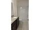 Well-lit bathroom features a double vanity with granite countertops and a shower-tub combo at 1926 Church Lake St, Groveland, FL 34736