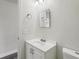 Clean, functional bathroom with a well-lit sink, toilet, and mirror at 610 Walker St, Holly Hill, FL 32117
