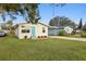Charming single-story home featuring a well-manicured lawn and a bright blue front door at 610 Walker St, Holly Hill, FL 32117