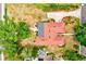 Expansive aerial view of a cozy home with a well-maintained red roof and a lush green yard with mature trees at 1546 Stormway Ct, Apopka, FL 32712