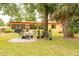 Relaxing backyard seating area with mature landscaping and a view of the home's cozy screened-in porch at 1546 Stormway Ct, Apopka, FL 32712