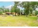 Expansive backyard featuring lush green grass, mature trees, and a cozy patio area perfect for outdoor relaxation at 1546 Stormway Ct, Apopka, FL 32712