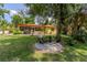 Large backyard featuring mature trees, a patio with furniture, and a screened porch at 1546 Stormway Ct, Apopka, FL 32712
