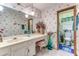 Bathroom featuring white floral wallpaper, sink vanity, large mirror, and a toilet in an adjoining space at 1546 Stormway Ct, Apopka, FL 32712