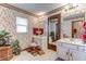 Vintage bathroom features floral wallpaper, dual vanities, and ample natural light, showcasing classic charm at 1546 Stormway Ct, Apopka, FL 32712