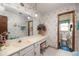 Bathroom featuring white floral wallpaper, sink vanity, large mirror, and a toilet in an adjoining space at 1546 Stormway Ct, Apopka, FL 32712