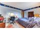 Bedroom with blue decorative border, blue curtains, a bed, a wardrobe, and a desk at 1546 Stormway Ct, Apopka, FL 32712