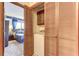 Bedroom view showcases a laundry setup inside a wood-trimmed closet, complementing the decor seen through the doorway at 1546 Stormway Ct, Apopka, FL 32712