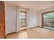 Neutral bedroom featuring a large window with sunlit, cozy carpet and white walls at 1546 Stormway Ct, Apopka, FL 32712