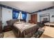 Comfortable bedroom with a queen-sized bed, dark wood furniture, and sun and moon themed decorations at 1546 Stormway Ct, Apopka, FL 32712