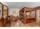Warm bedroom featuring a four-poster bed, wood furnishings, and decorative accents for a cozy retreat at 1546 Stormway Ct, Apopka, FL 32712