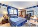 Bedroom with blue decorative border, blue curtains, a bed, a wardrobe, and a desk at 1546 Stormway Ct, Apopka, FL 32712