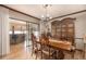 Inviting dining room featuring a wood table, chandelier, and sliding doors leading to the enclosed patio at 1546 Stormway Ct, Apopka, FL 32712