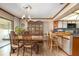 Elegant dining room featuring a wood table, chairs, hutch, and breakfast bar that opens into the kitchen at 1546 Stormway Ct, Apopka, FL 32712