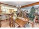 Traditional dining room with wood table and chairs that opens into the kitchen at 1546 Stormway Ct, Apopka, FL 32712