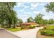 Spacious home with a long driveway, well-maintained landscaping, and mature trees providing shade and curb appeal at 1546 Stormway Ct, Apopka, FL 32712