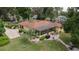This single-Gathering home features a covered patio, well-maintained lawn, and mature trees for outdoor enjoyment at 1546 Stormway Ct, Apopka, FL 32712