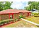 Brick home with a red roof and manicured landscaping showcasing its charming curb appeal and well-maintained exterior at 1546 Stormway Ct, Apopka, FL 32712