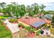 Charming home boasts mature landscaping, a long driveway, and a relaxing screened-in porch for outdoor enjoyment at 1546 Stormway Ct, Apopka, FL 32712