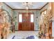 Elegant foyer featuring stylish wallpaper, tile flooring, and decorative accents creating a sophisticated entryway at 1546 Stormway Ct, Apopka, FL 32712