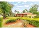 Beautifully landscaped front yard featuring manicured hedges and colorful mulch beds creating a welcoming curb appeal at 1546 Stormway Ct, Apopka, FL 32712