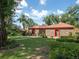 A neatly landscaped front yard with a brick home, complemented by mature trees at 1546 Stormway Ct, Apopka, FL 32712