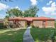 Charming brick home with a well-manicured lawn and inviting pathway leading to the front door at 1546 Stormway Ct, Apopka, FL 32712