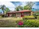 A neatly landscaped front yard with a brick home, complemented by mature trees at 1546 Stormway Ct, Apopka, FL 32712