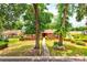 Charming single-story brick home with a well-manicured lawn, mature trees, and walkway to a red front door at 1546 Stormway Ct, Apopka, FL 32712
